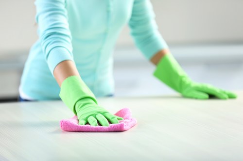 Cleaner working on modern apartment windows in Canary Wharf