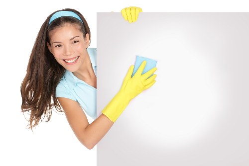 Local cleaner treating coffee and wine stains in a modern Canary Wharf apartment