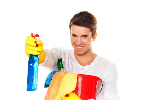 Professional cleaner maintaining a shared office kitchen and break area in Canary Wharf